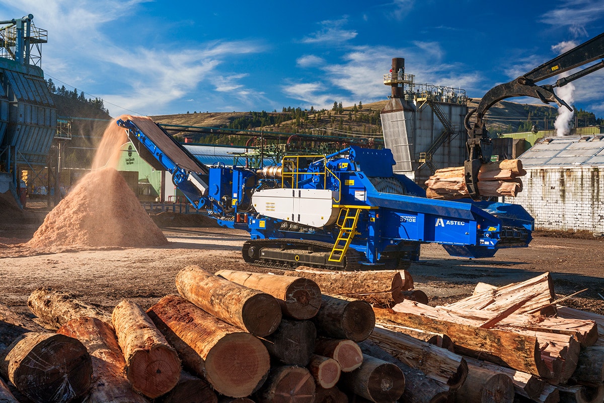 Peterson 3710E horizontal grinder at a saw mill processing logs.