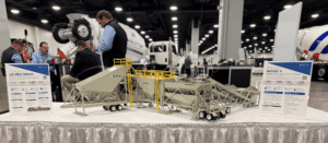 3D-printed scale model of the CON-E-CO Lo-Pro 327SS concrete batch plant displayed on a tabletop, showcasing the plant’s structural components and equipment details in miniature form.